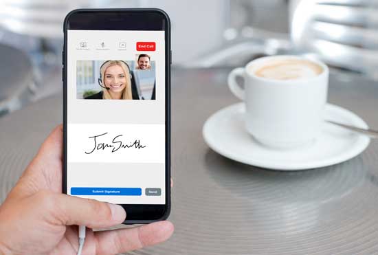 Man looking at smartphone meeting with agent, coffee cup in background