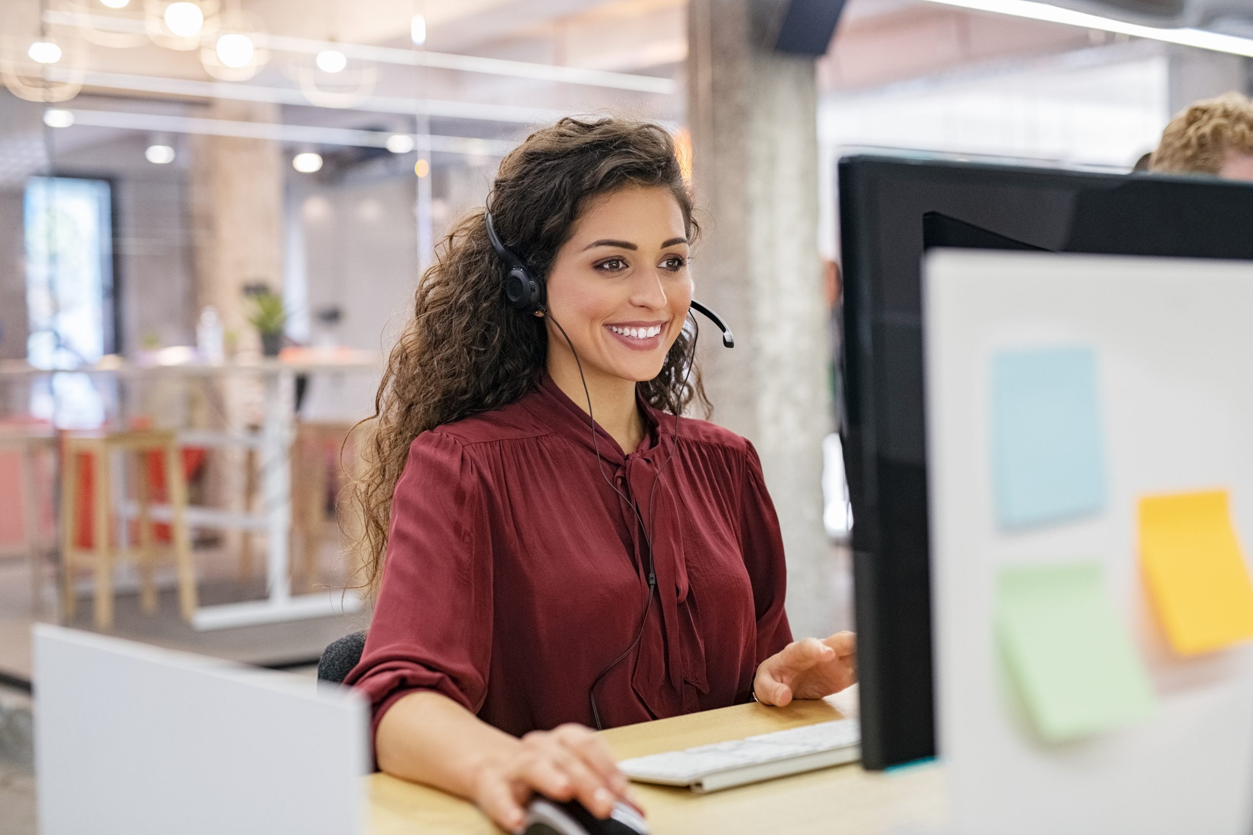 Woman talking on headset.